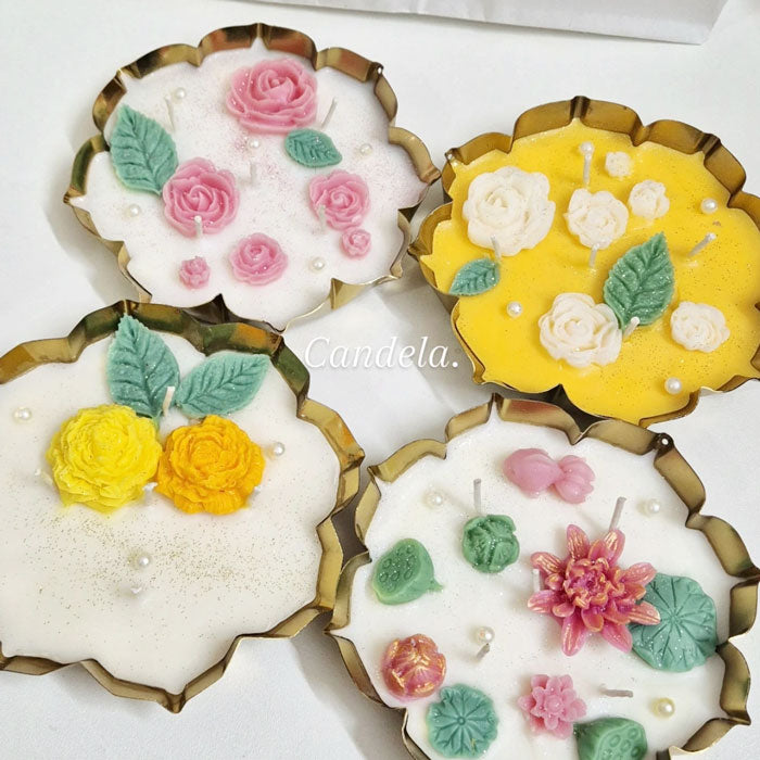 Decorative Urli candles with floral embellishments in White Rose and Lotus Pond designs