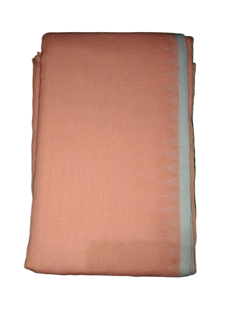 Folded peach-colored fabric on a green surface