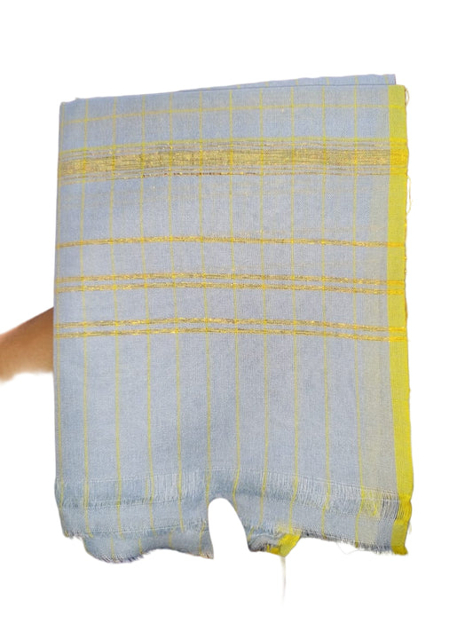 Handheld fabric with yellow and blue checkered pattern in a store setting