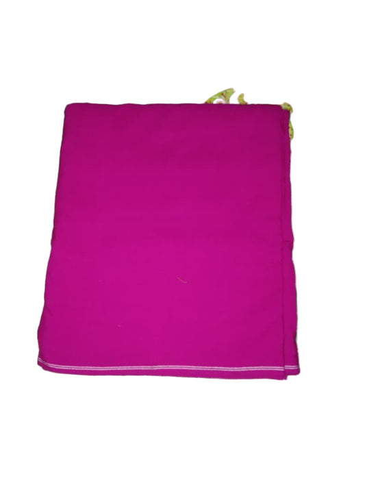 Pink fabric on a green floral-patterned surface