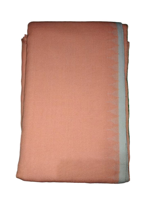 Folded peach-colored fabric on a green surface