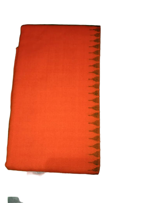 Orange fabric on a green surface with a floral pattern