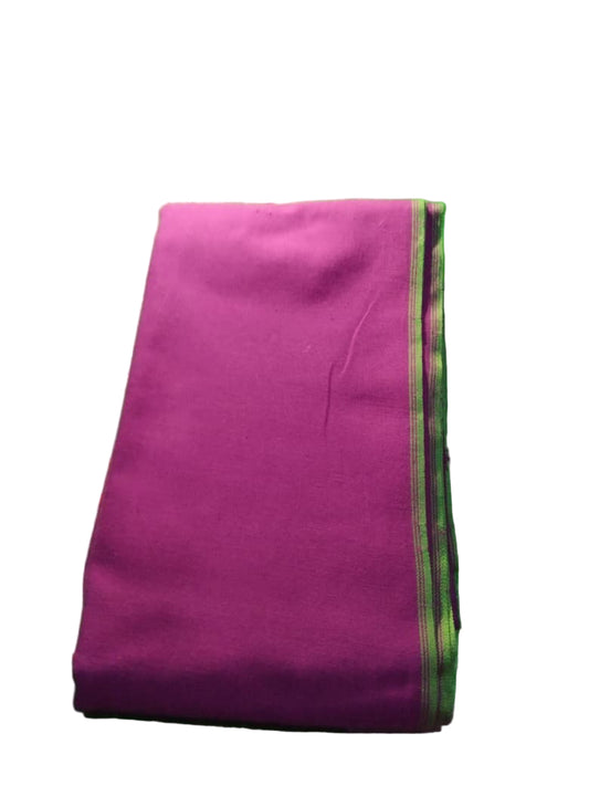 Folded pink fabric on a green textured surface